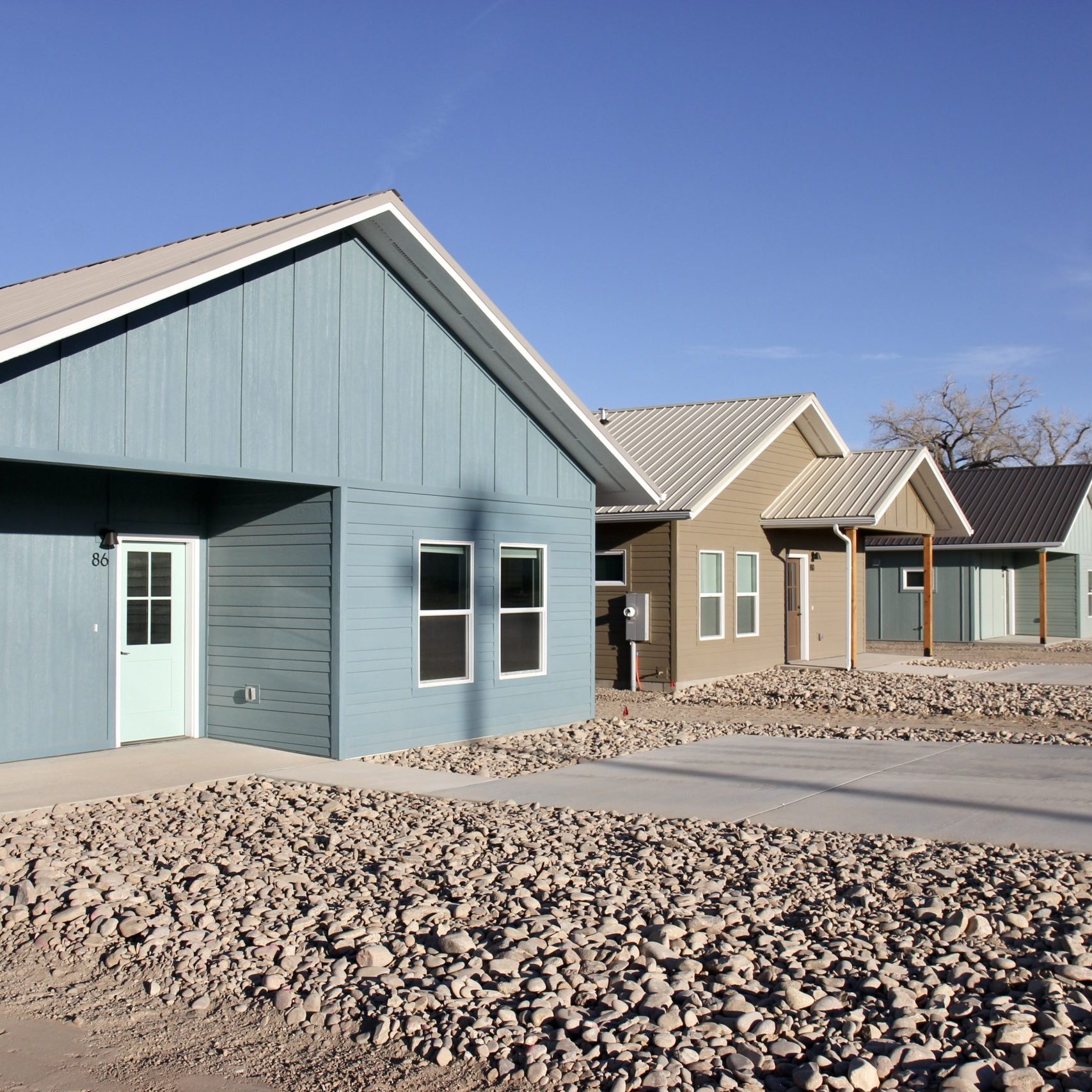 Each house alternates between three and two bedroom designs that all have front porches and xeriscaping, with more landscape development to come.